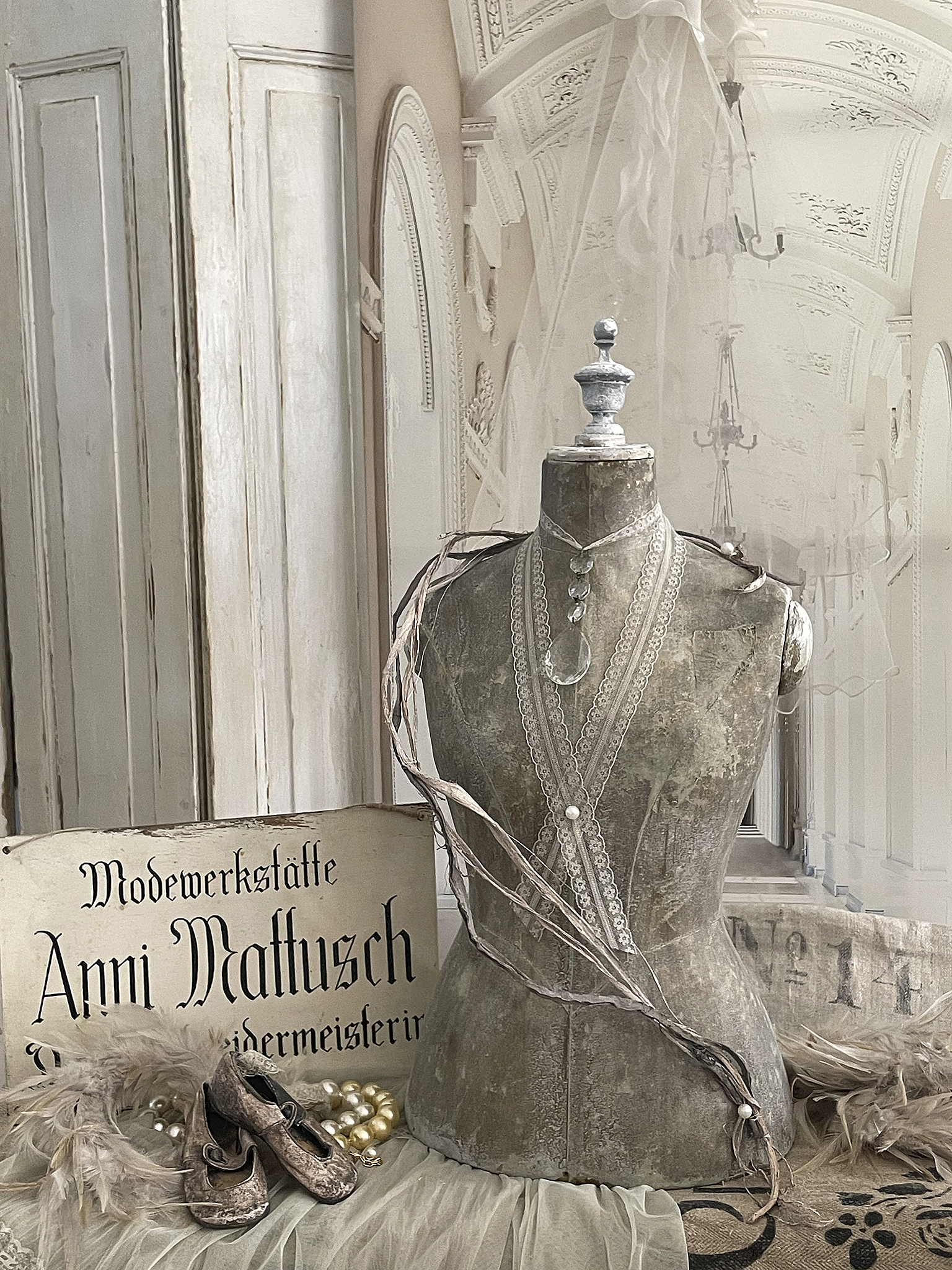 Antike Schneiderpuppe in einem stilvollen Ambiente mit Schmuck und alten Schuhen