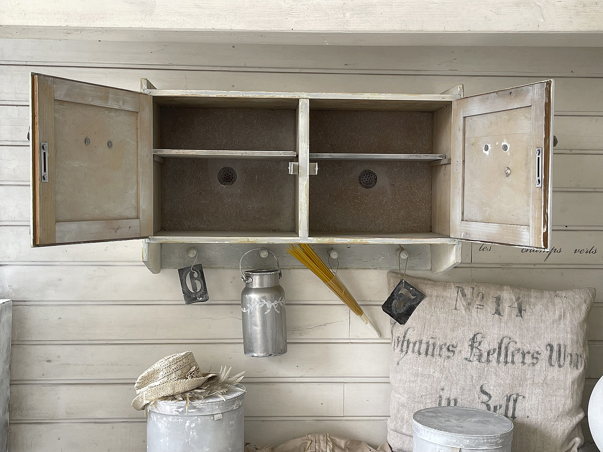 Vintage Wandschrank mit offenen Türen und nostalgischem Zubehör Holzschrank mit zwei offenen Fächern und dekorativen Accessoires