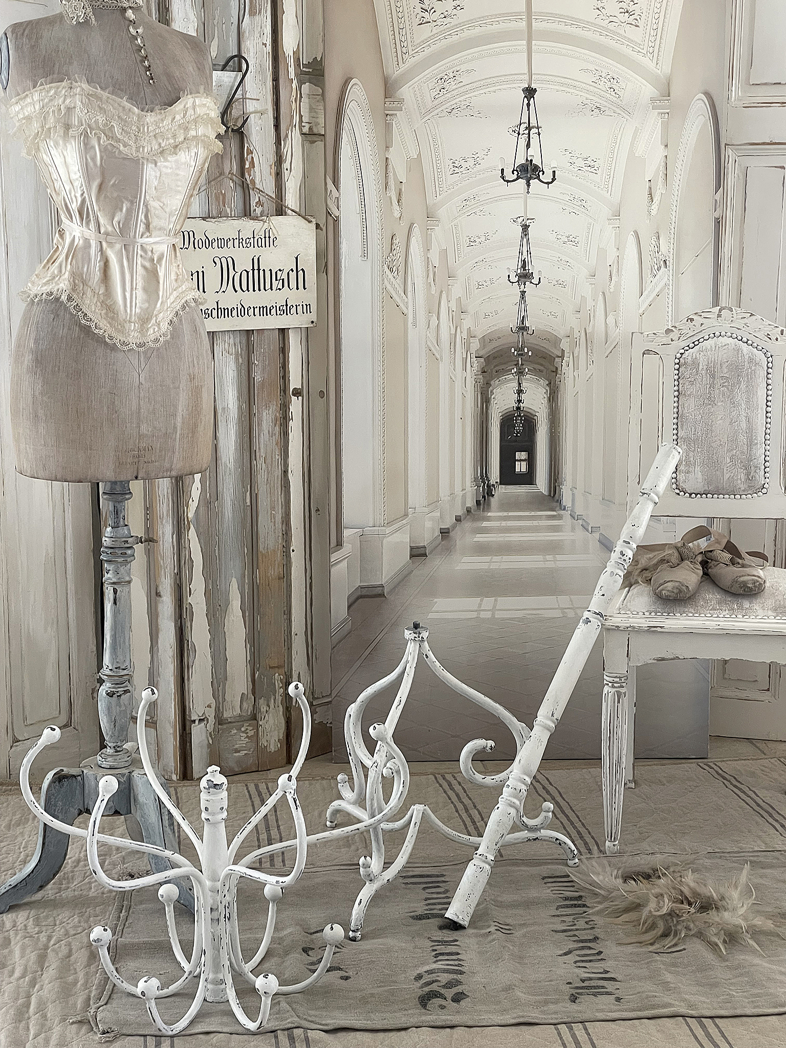 Elegante Modewerkstatt mit antiken Accessoires in stilvollem Ambiente Antike Mannequin und weißes Dekor in einer eleganten Modewerkstatt