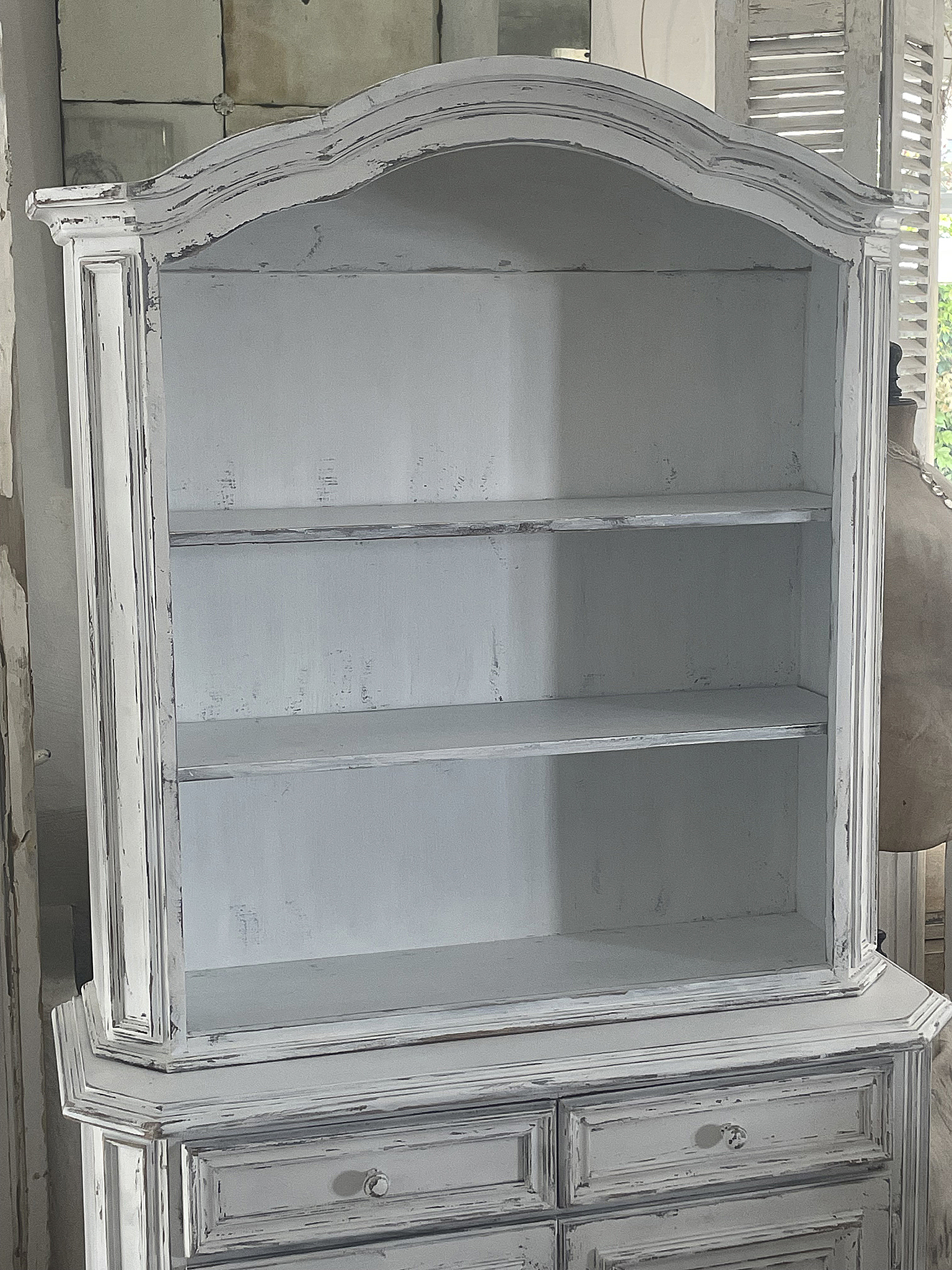 Vintage Bücherregal im Shabby-Chic-Stil Helles, vintage Bücherregal mit offenen Regalen und geschlossene Schubladen im Shabby-Chic-Stil.