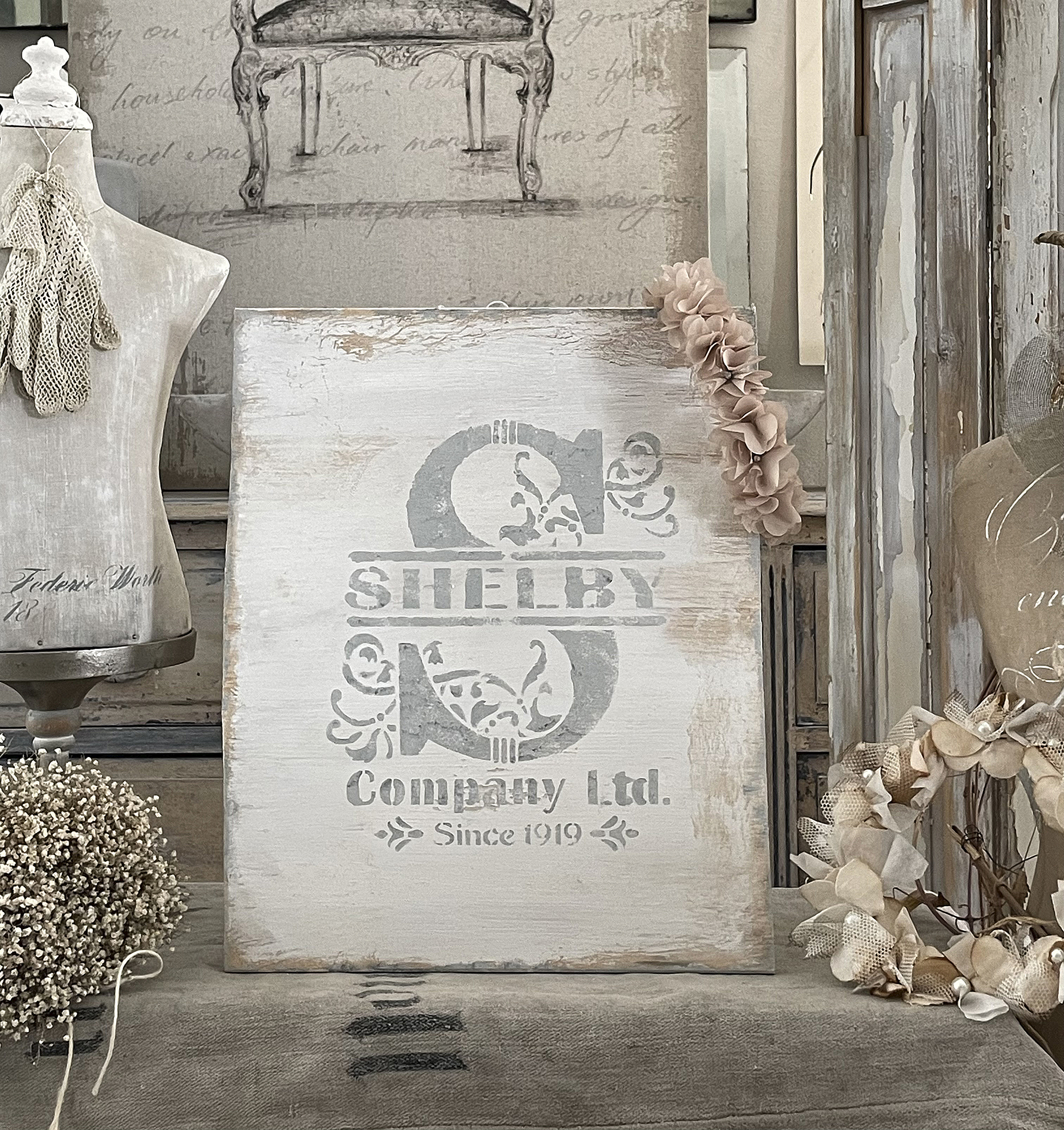 Holzschild mit dem Schriftzug Shelby Company Ltd. und floralem Design, seit 1919