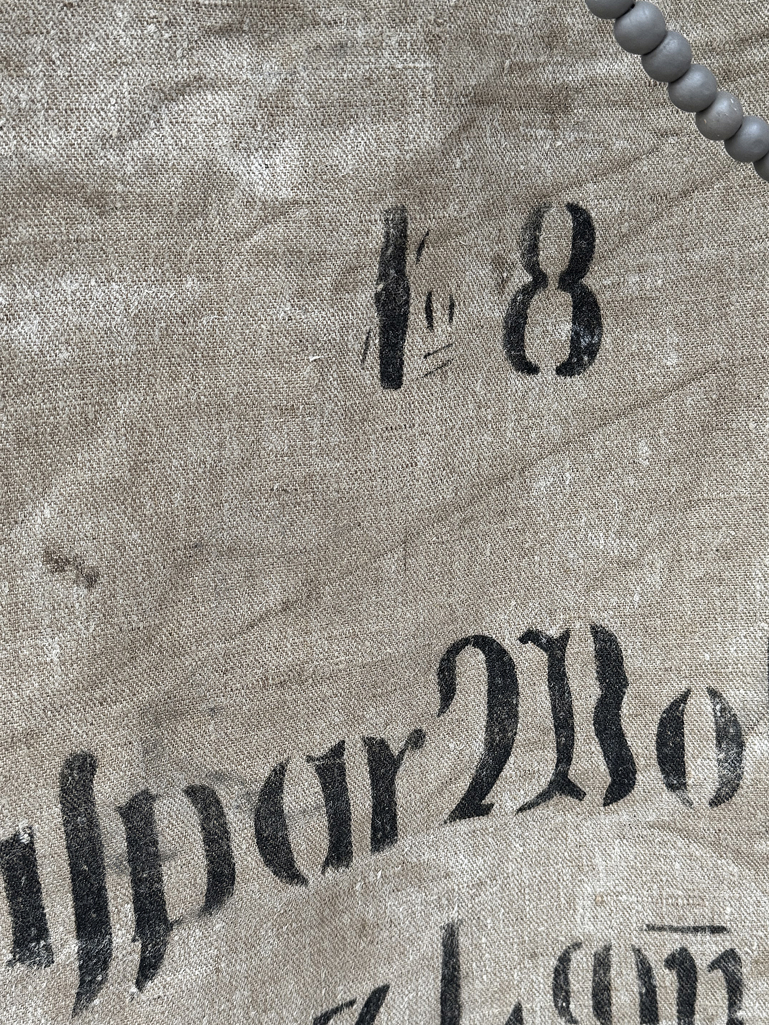Detailaufnahme einer vintage Stofftasche mit aufgedruckten Zahlen und Schrift Nahaufnahme von einem alten Stoff mit nummerierten und beschriebenen Details
