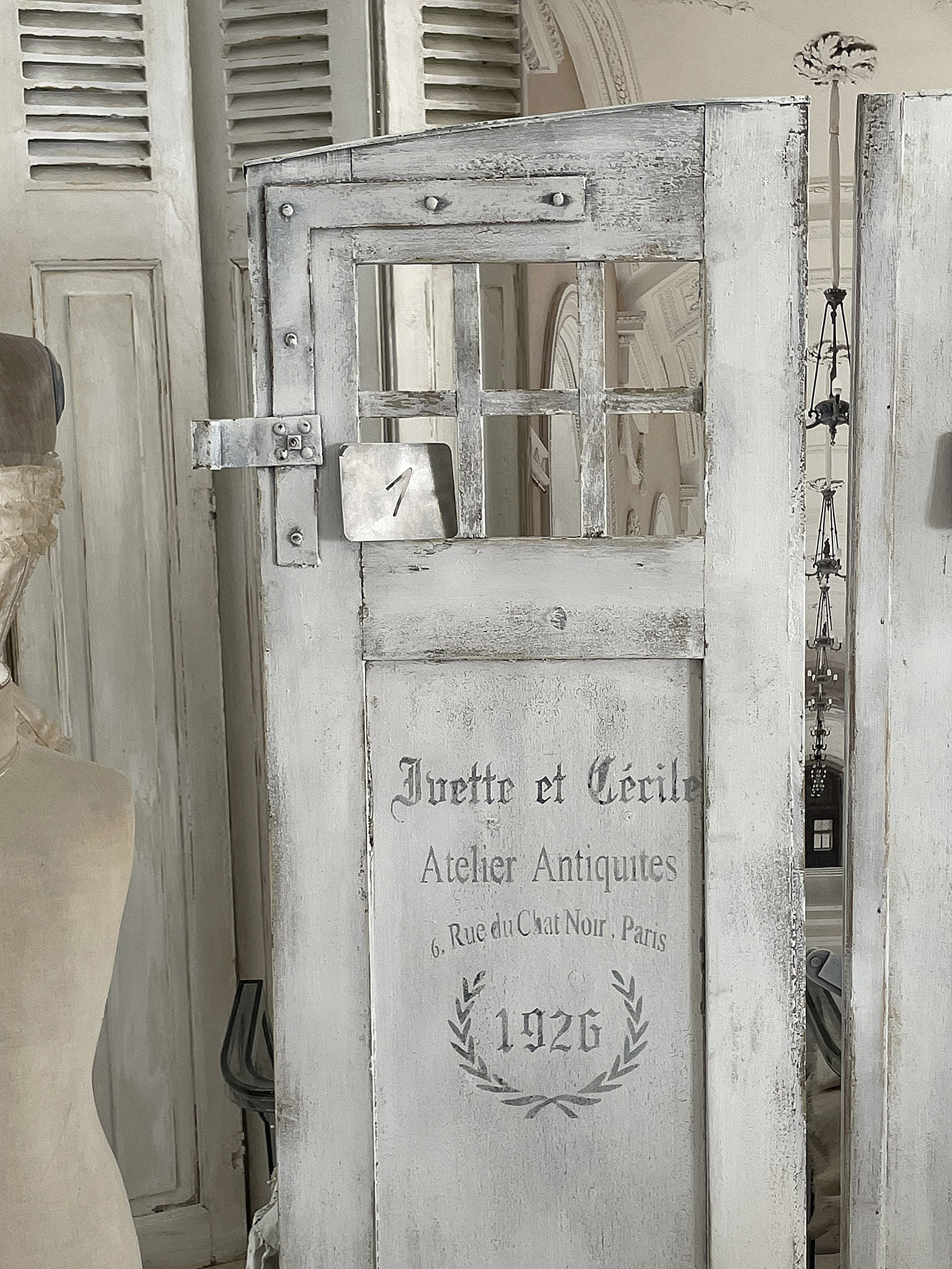 Detailansicht einer antiken Tür mit Aufschrift und dekorativen Elementen aus dem Atelier Antiques