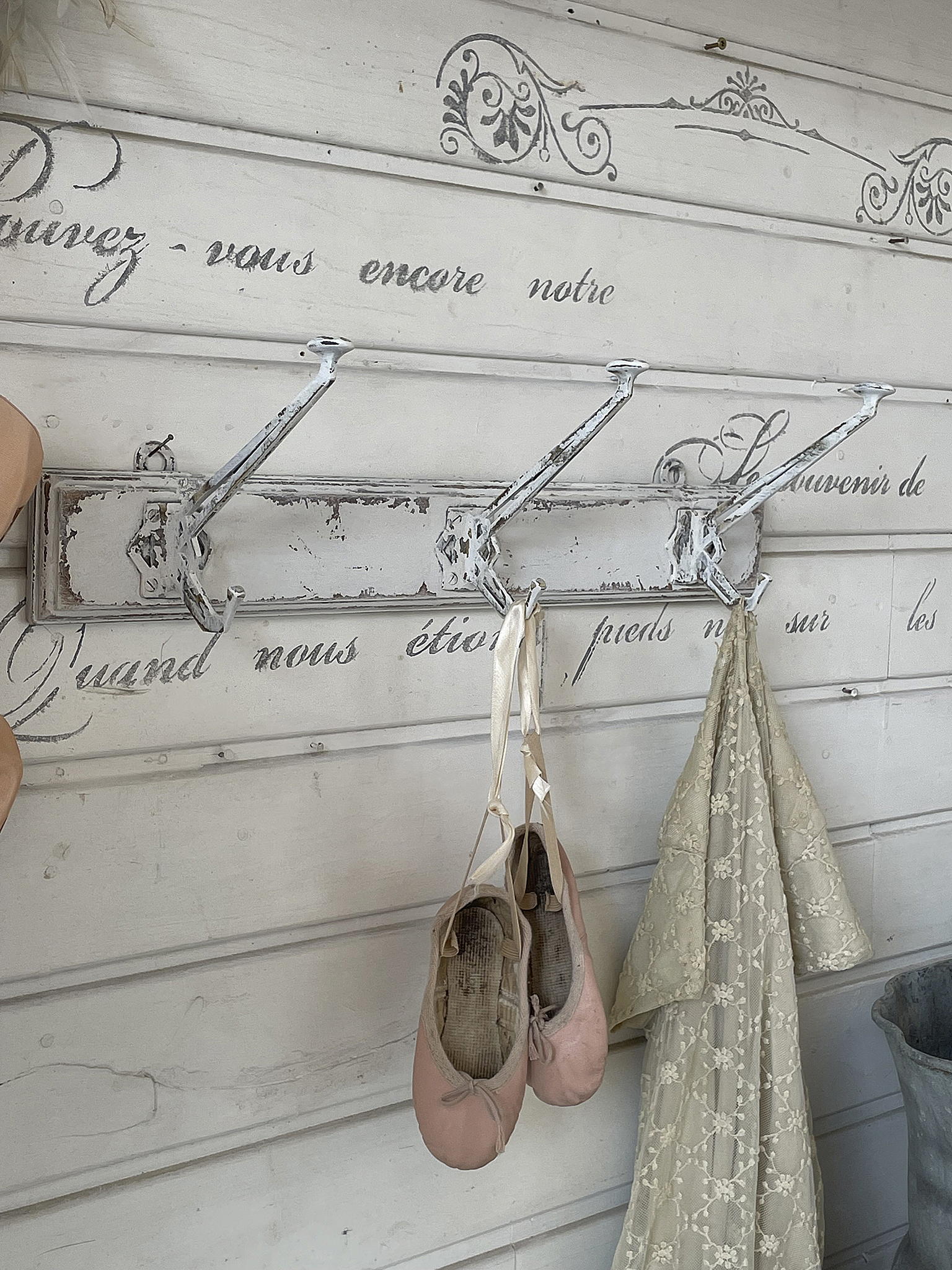 Ballettschuhe und ein weiches Kleid an einem vintage Wandhaken, dekorativer Hintergrund